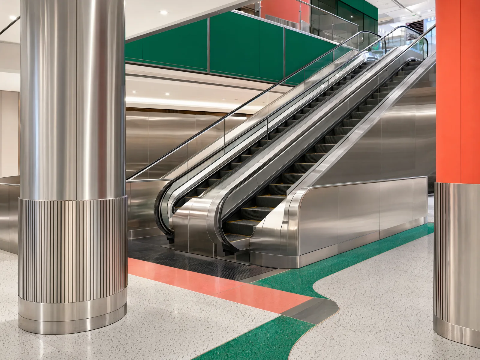 Representative mall public area with decorative stainless escalator-side cladding and column wraps